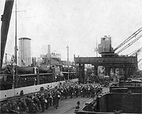 Photo # NH 105492: USS Lancaster loading homeward bound troops in 1919