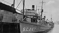 Photo # NH 41990: Freighter Clio in the background of a photo of USS SC-267 at Wakefield, Massachusetts, circa 1918-1919